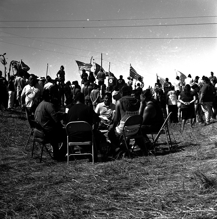 Remaining non-violent, the protectors have taken to prayer, singing, and the playing of the drums. Dustin White photo.